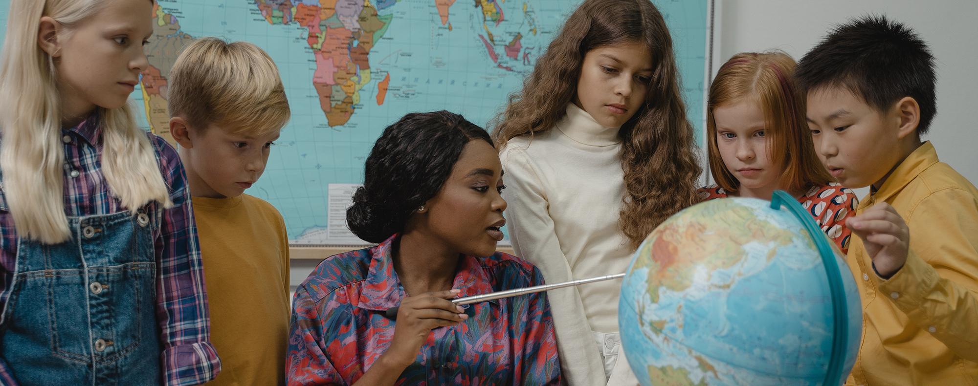 Teacher showing students a globe